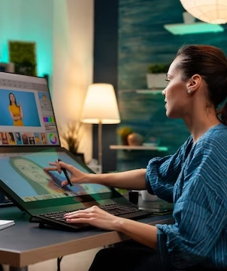 Best Branding Services in Coimbatore For Digital Marketing The woman sits in a chair and uses her laptop to project a display of a digital drawing on the screen.