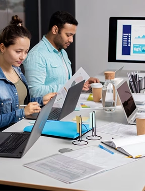 Best Digital Marketing Solution and Services in Gandhipuram A group of people working productively at a workplace while utilizing laptops at their desks.