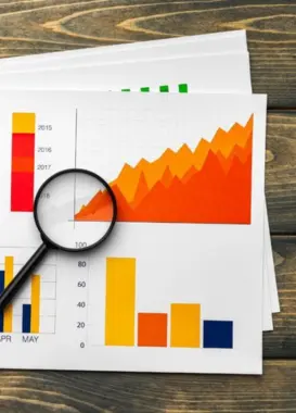 Top Brand Promotion Agencies And Professionals in Coimbatore A marketing specialist analyzes the business plan for growth using traffic data put by graphs.