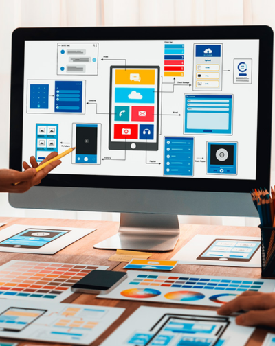 Top Designers Collaborate on UI/UX Interface & Mockups Designers collaborating on a computer interface layout, with UI/UX wireframes, color palettes, and mockups.