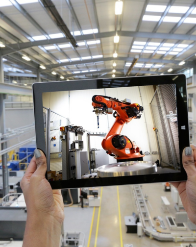 Industrial Video Production Agency in Ram Nagar, Coimbatore A tablet that someone is carrying displays a robot that stands for industrial video production.