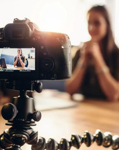 Best Product Demonstrations Video Producers in Coimbatore A professional influencer women recording a video on a video camera for social media presence.